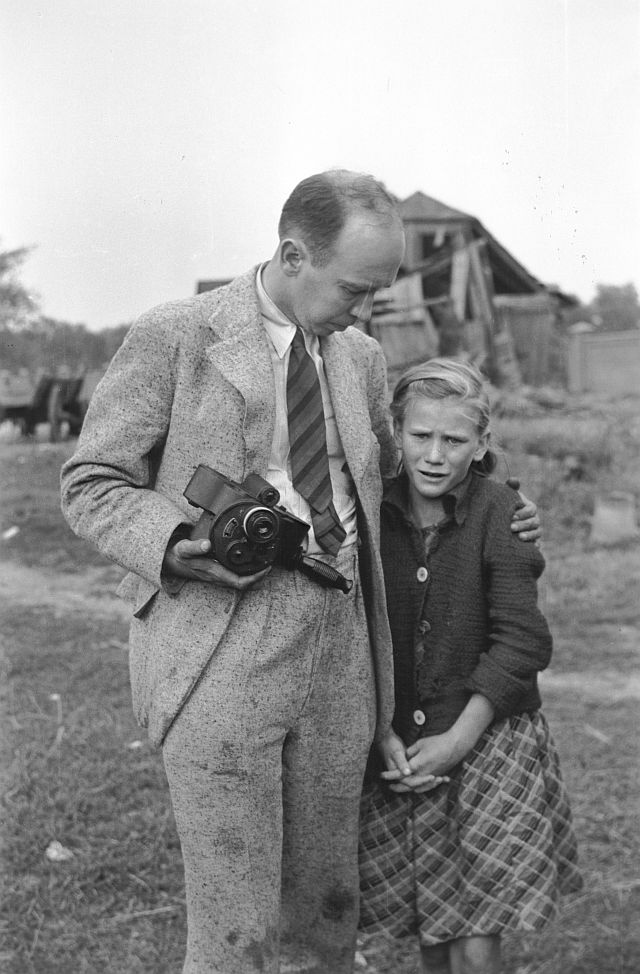 Julien Bryan comforts 10-year-old Kazimiera Mika, her 16-year-old sister had just been machine-gunned by Nazi German fighter plane